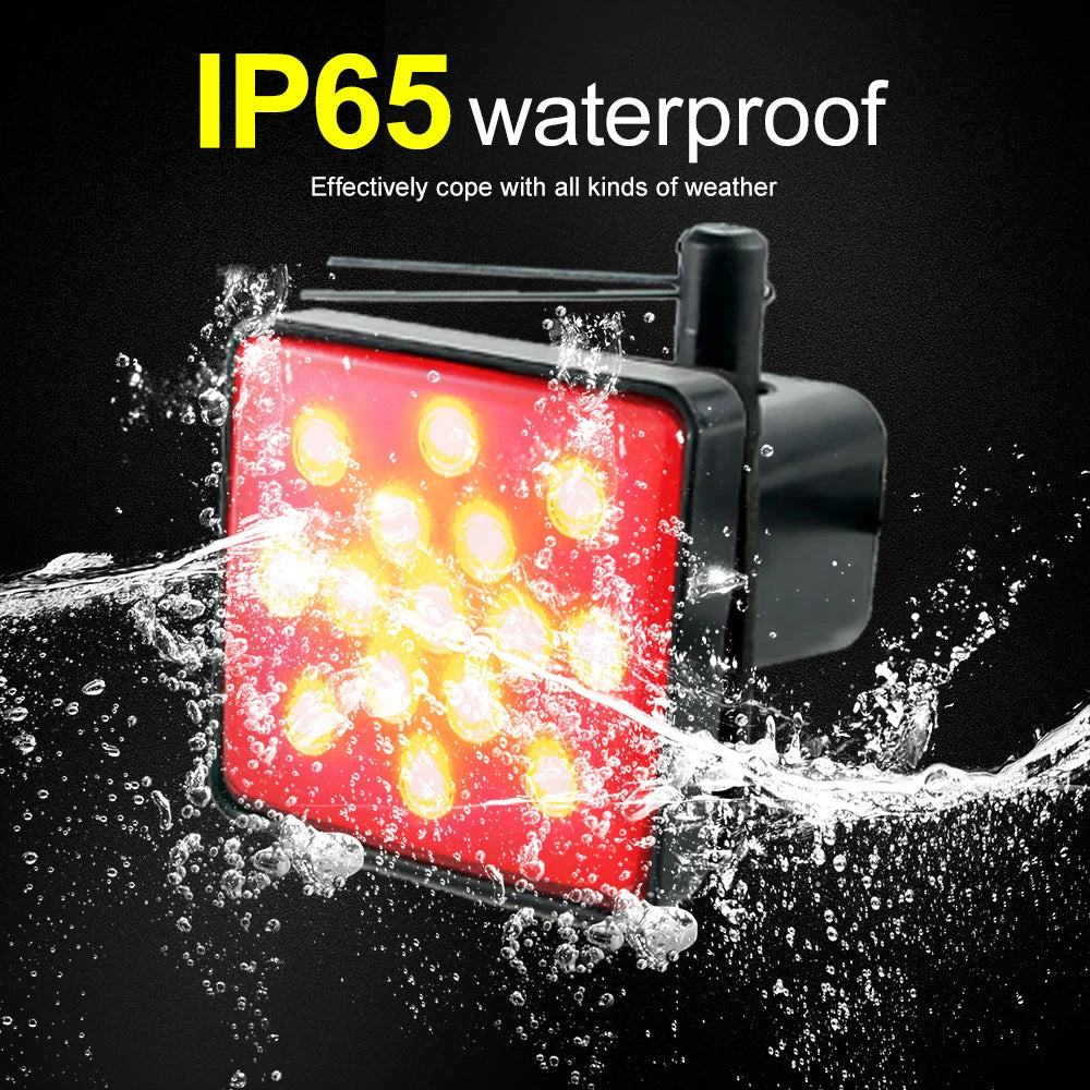 A red LED trailer hitch light cover is shown being splashed by water, demonstrating its waterproof IP65 protection.
