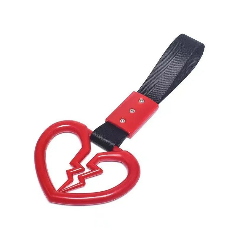 A black strap with a red heart charm, used for securing items.
