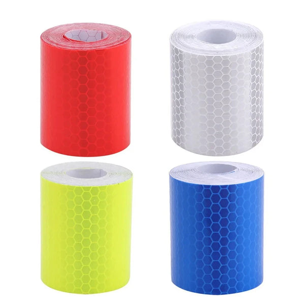 Three rolls of high-visibility reflective tape in red, white, and blue.