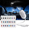 A white projector night light device is shown next to a car interior with a starry sky view.