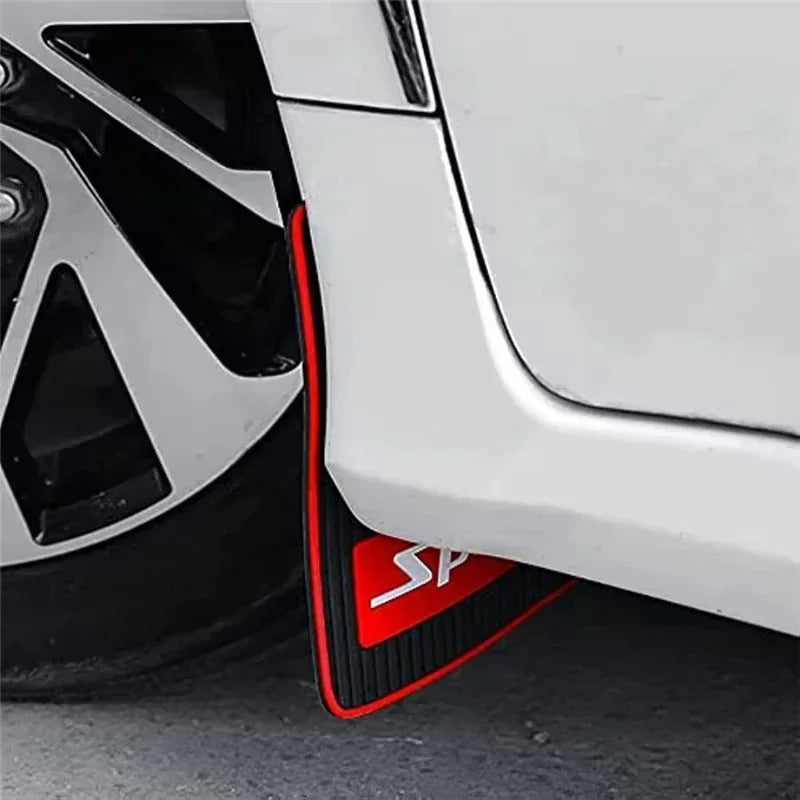 Red rubber mud flaps installed on a white vehicle wheel arch.