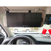 A black leather sun visor extender is mounted on a car's interior, positioned above the dashboard.