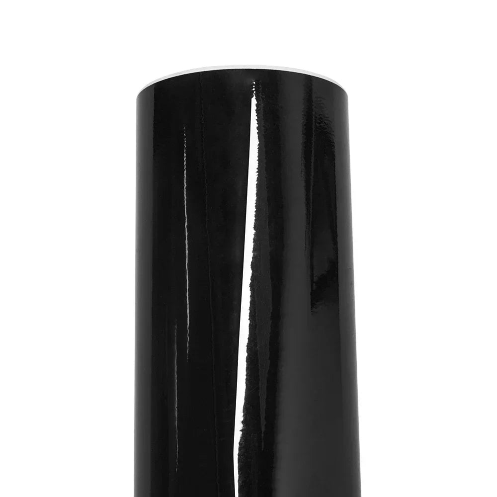 A close-up view of a glossy black car wrap film decal tube.