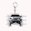 Silver acrylic keychain featuring a detailed off-road truck model.