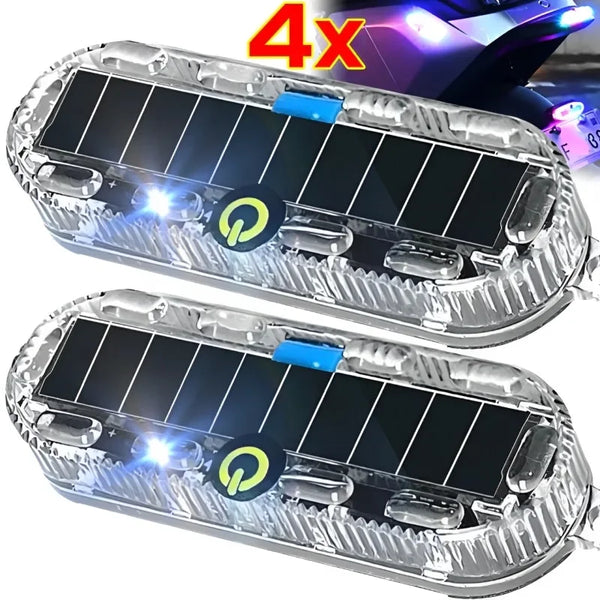 Two clear plastic solar LED warning lights with solar panels and blue accents shown against a dark background.