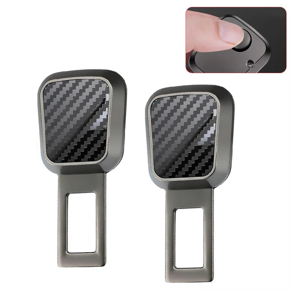 A pair of gray car seat belt extenders with quick-release buckles and carbon fiber accents.