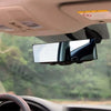 A clip-on wide angle rear view mirror is mounted inside a vehicle, showing the exterior view.