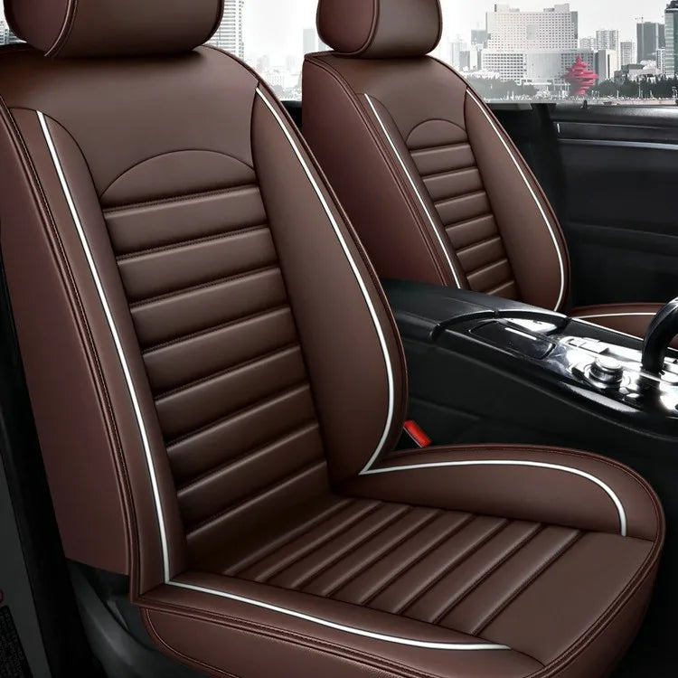 A close-up view of a brown leather car seat with stitching and a white accent stripe inside a vehicle.
