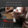 Close-up of hands hand-sewing a steering wheel cover using red thread and needle, emphasizing craftsmanship.