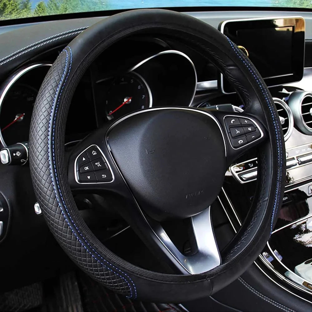 Black leather steering wheel cover with blue stitching inside a car interior.