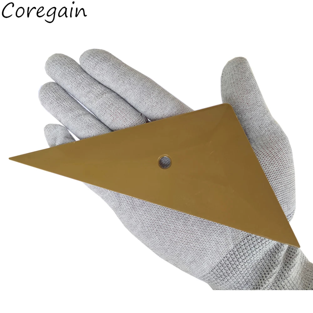 A hand wearing a gray glove holds a gold triangle squeegee tool.