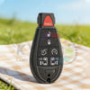 A black smart remote car key with a panic button and various electronic features resting on a checkered cloth.