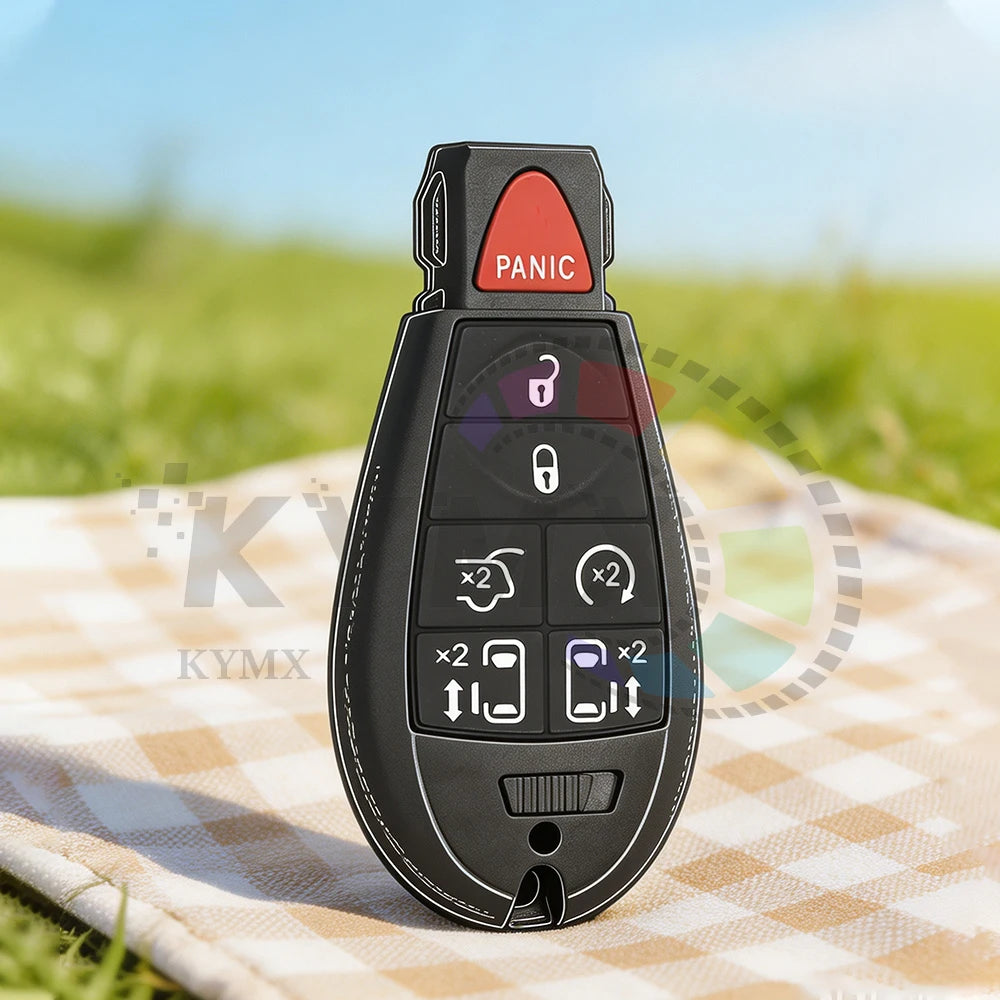 A black smart remote car key with a panic button and various electronic features resting on a checkered cloth.