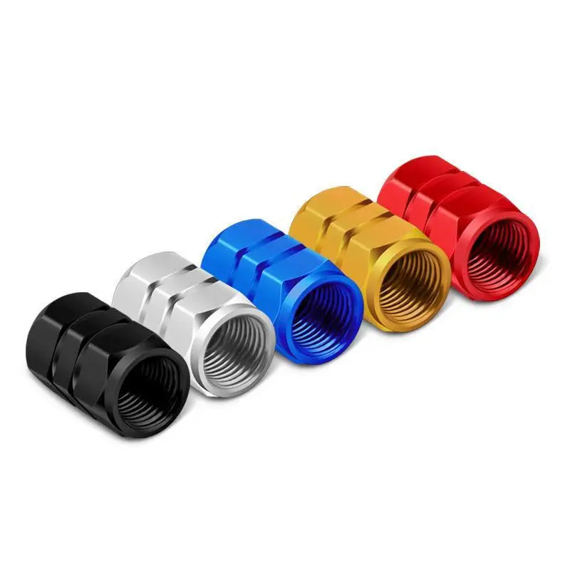 A set of four hex aluminum alloy tire valve caps in red, gold, blue, and silver.