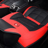 Red and black quilted car seat covers with a black console visible in a vehicle interior.