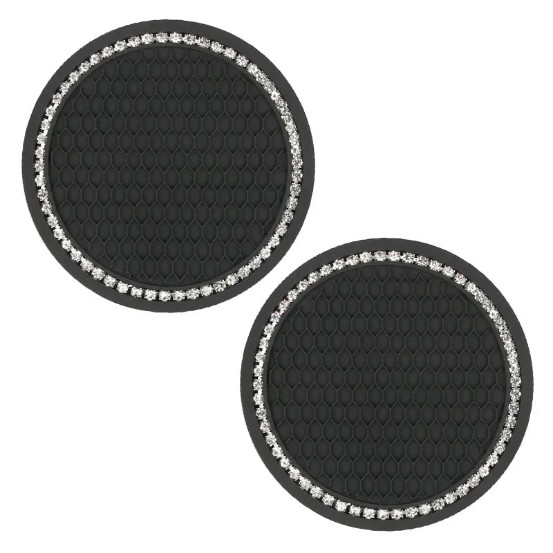 A set of two black silicone car cup coasters, each rimmed with silver glitter.