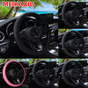Black steering wheel cover with pink accents and embossed PU leather texture shown in a car interior context.
