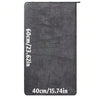 A dark gray microfiber car drying towel with dimensions listed in centimeters and inches.