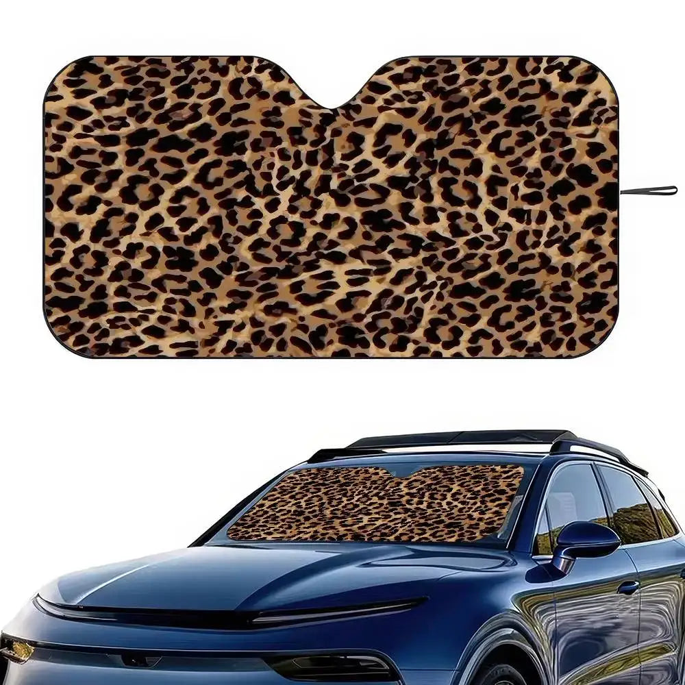 A leopard print car sunshade applied to the windshield of a blue car.
