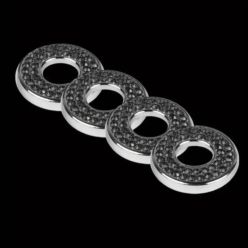 A set of six round, clear gemstone door lock pin trim pieces arranged in a line against a black background.