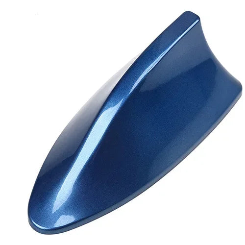 A glossy dark blue shark fin decorative car antenna cover viewed from above.