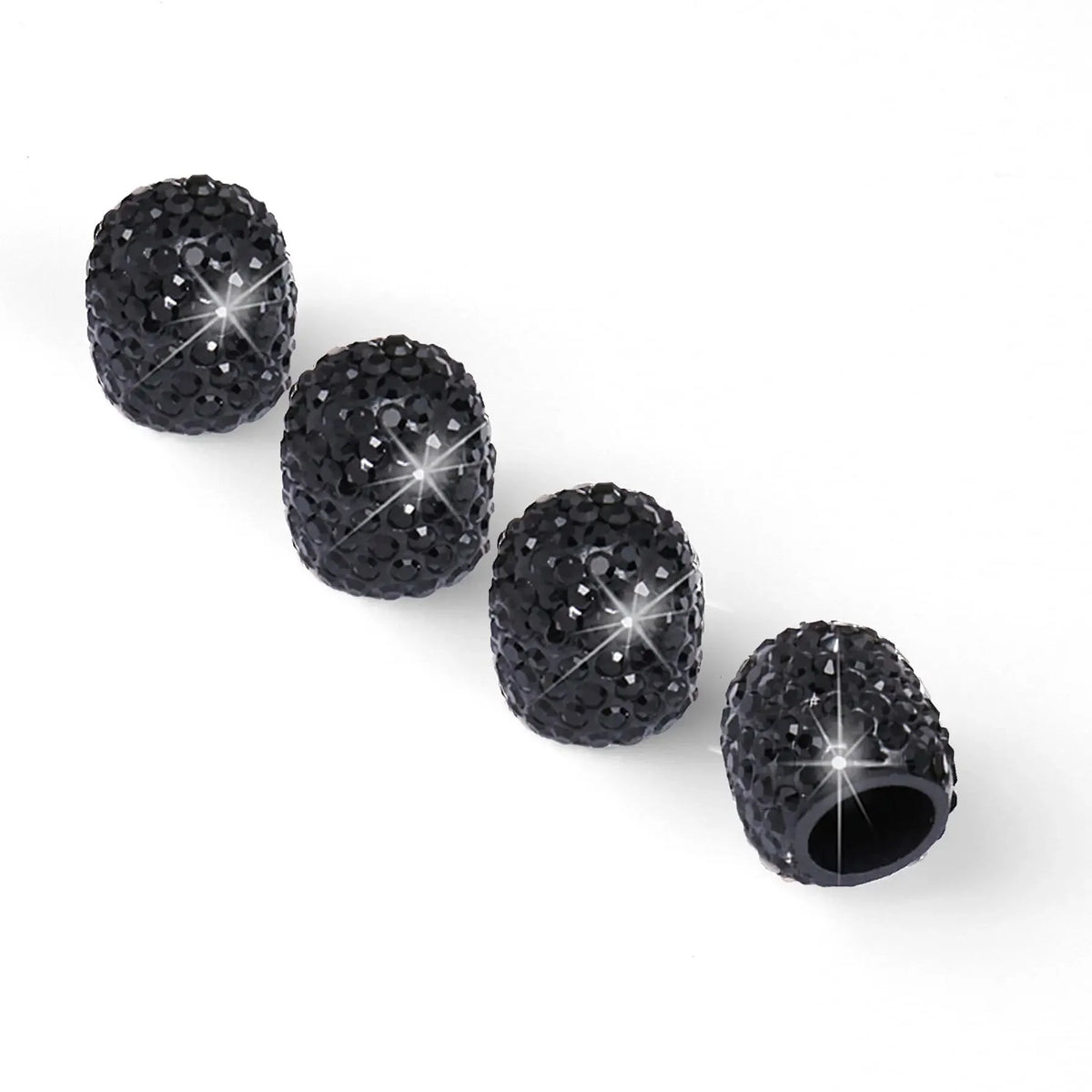 Eine Reihe schwarzer Diamant-besetzter Felvndichtungsdeckel mit verschiedenen Texturen und Oberflächen.