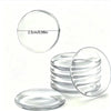 A stack of crystal clear ignition button protectors, showing a circular disc measuring 2.5cm or 0.98in.