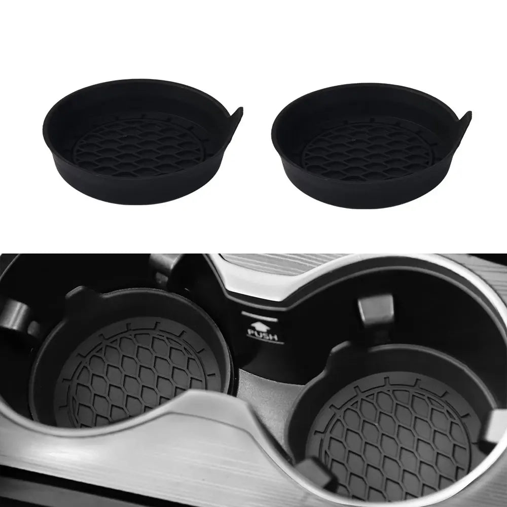 A set of two black silicone cup holder coasters shown from the top and a close-up view inside a holder.