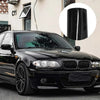 A glossy black BMW sedan parked outdoors with a circular inset showing a close-up of the car's finish.