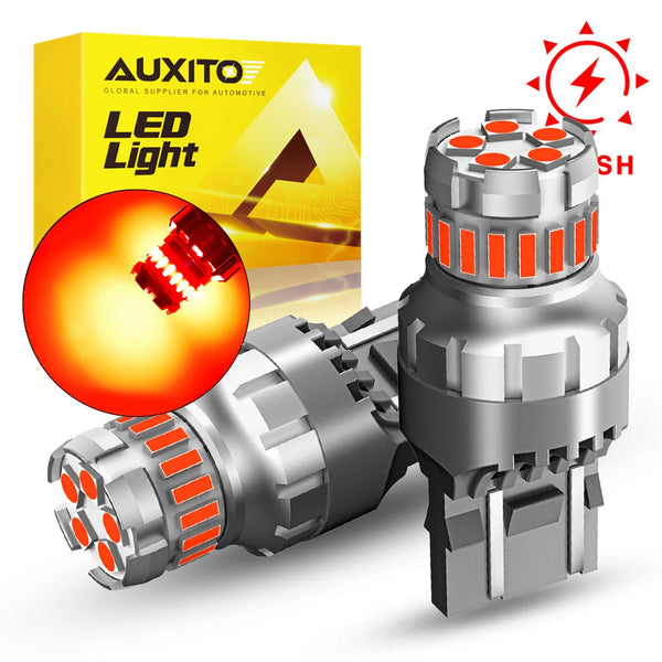 A package of AUXITO LED Light products and a silver strobe brake light bulb with dual sockets.