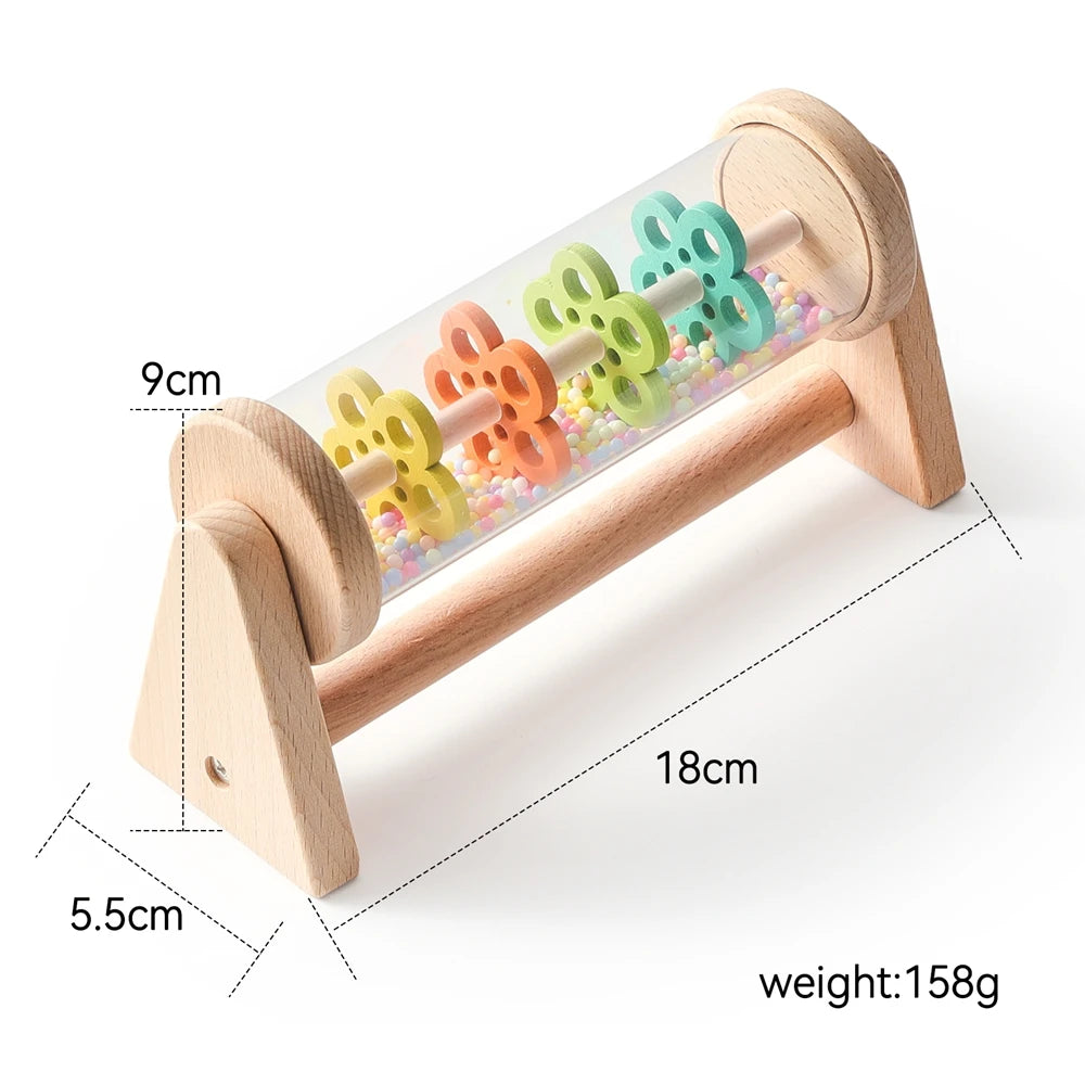 A wooden rainmaker musical toy with colorful plastic raindrops and a wooden frame.