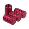A set of red aluminum tire valve caps with textured grips.
