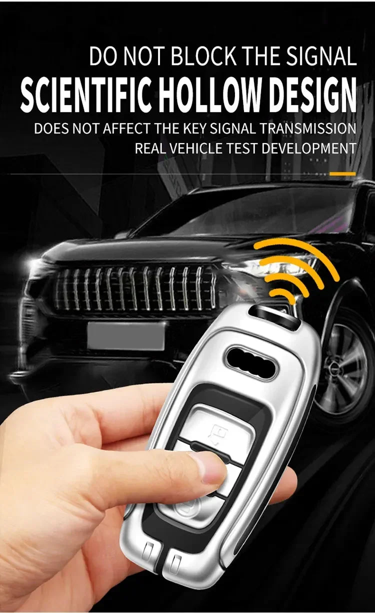 A hand holds a silver Audi Q5 key fob cover, demonstrating its design for signal transmission.