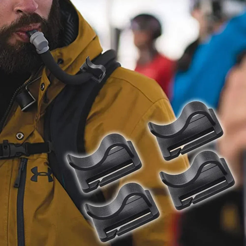 Close-up of a black hydration tube clip attached to a yellow jacket, showing its function for backpack hydration.