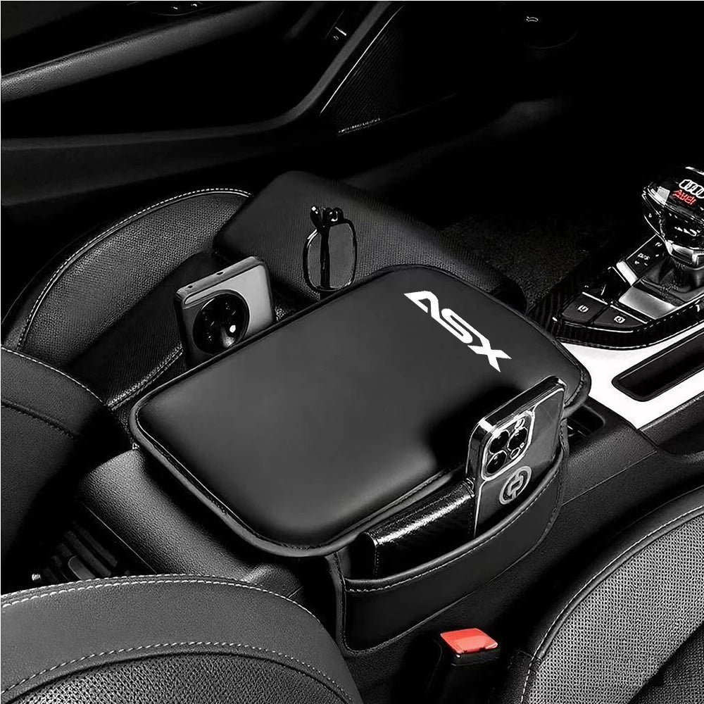 A black leather car armrest protector and storage pad is shown inside a car interior.