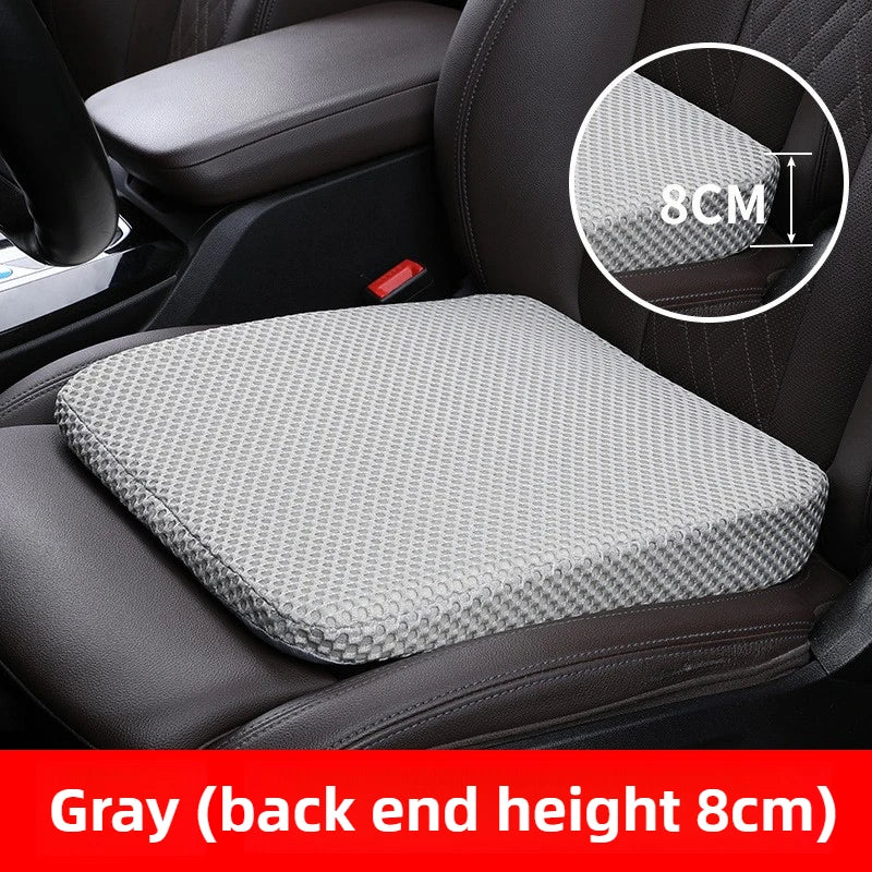 Gray honeycomb memory foam car seat booster cushion placed on a black car seat.