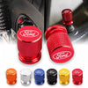 A collection of various colored and finish aluminum car wheel valve caps for different vehicle applications.