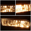 A pair of clear lens fog light assemblies for Chevy Silverado, Suburban, and Tahoe, showing bright illumination.