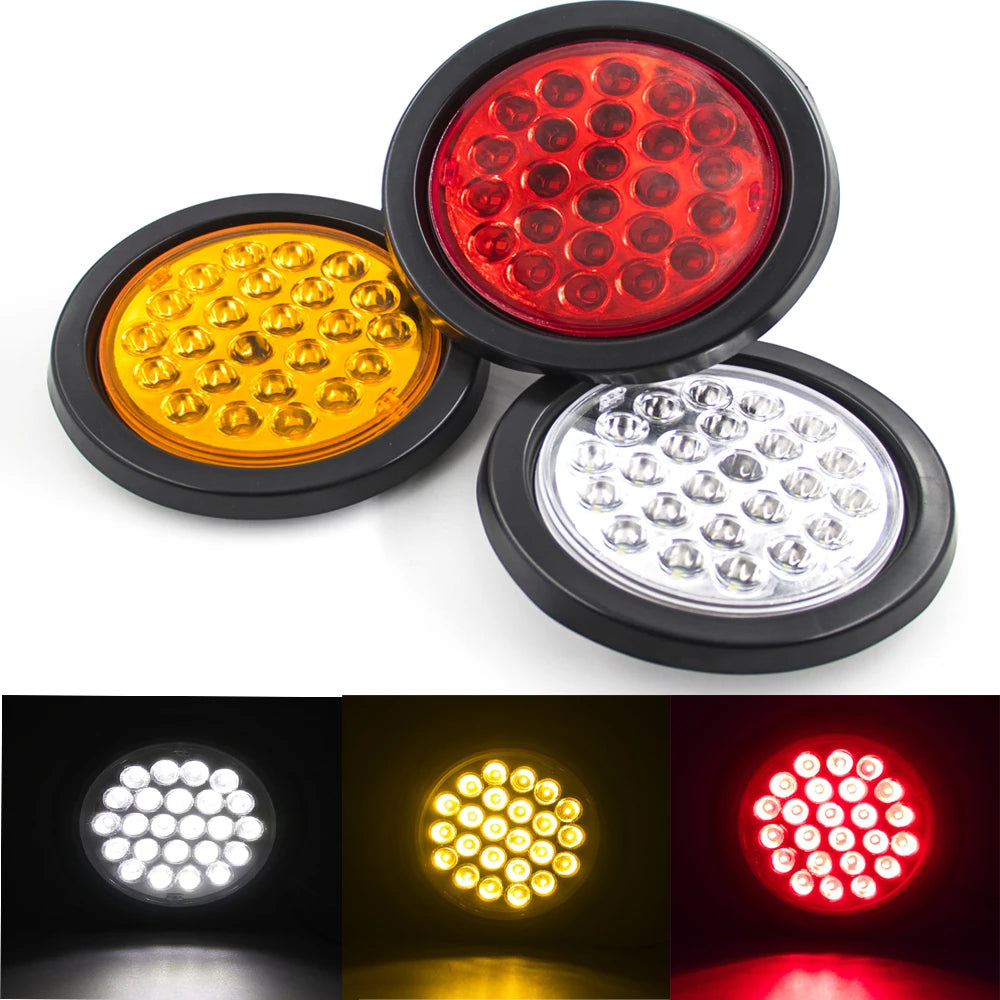 A set of three round LED trailer lights showing red, yellow, and white illumination.