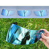 A close-up view of a motorcycle helmet visor shield with a blue tint, shown in various angles and in use outdoors.