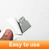 A close-up view of a silver 3D car exterior logo decal set for automotive use.