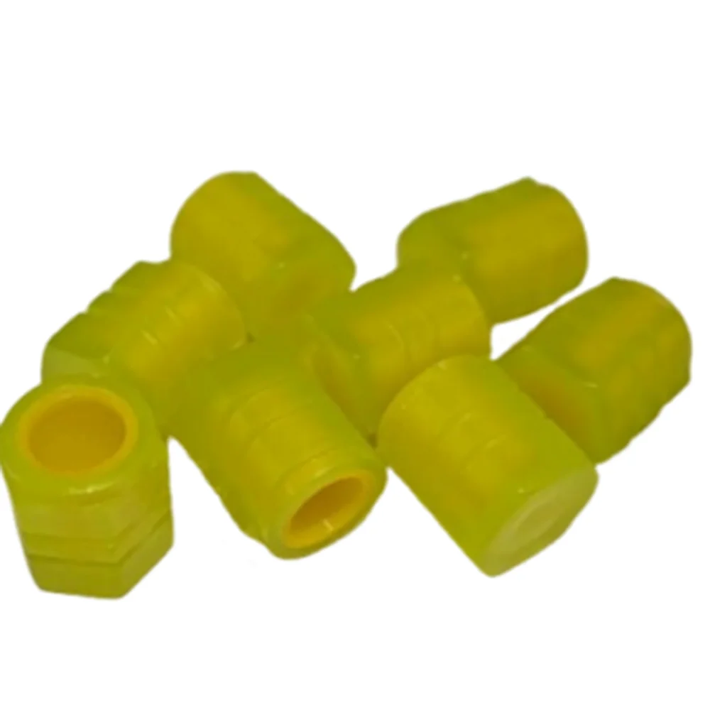 A collection of bright yellow self-luminous tire valve caps.