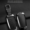A black aluminum alloy key fob cover is shown next to its original key, emphasizing full protection.