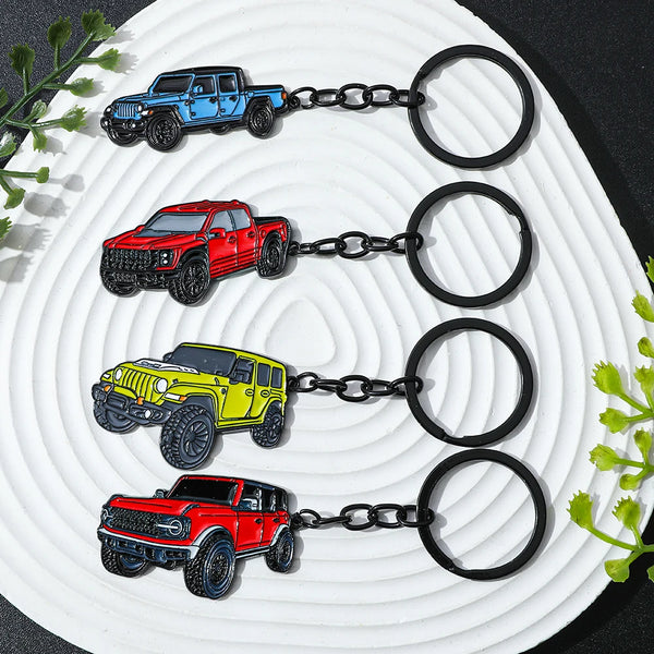 Four classic alloy car keychains in blue, red, yellow, and maroon are displayed on a white background.