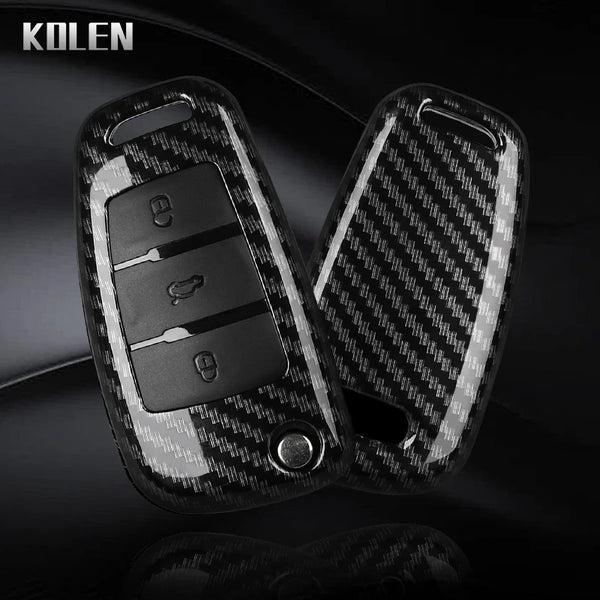 A black carbon fiber car key case cover with electronic features shown in a close-up view.