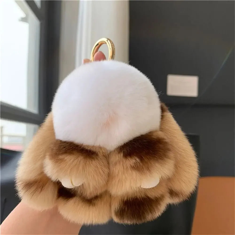 A plush bunny keychain featuring soft brown fur and a white nose, attached to a gold ring.