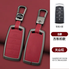 A pair of red car key cases with silver metal clasps and black electronic features displayed on a maroon background.