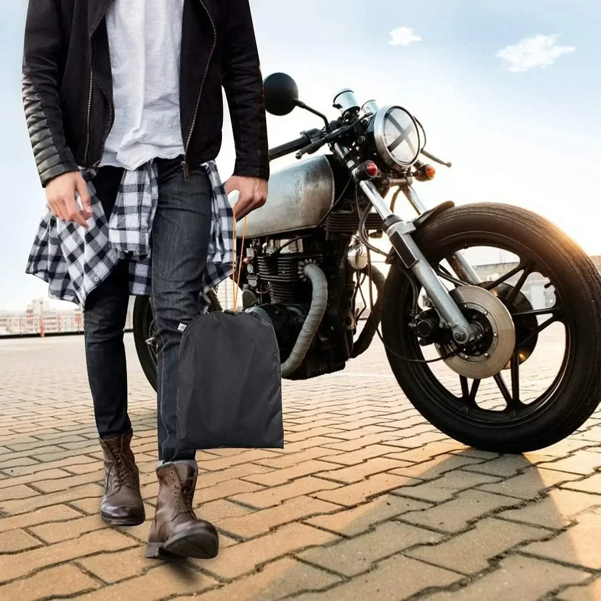A person stands next to an All-Season Motorcycle Cover on a motorcycle.