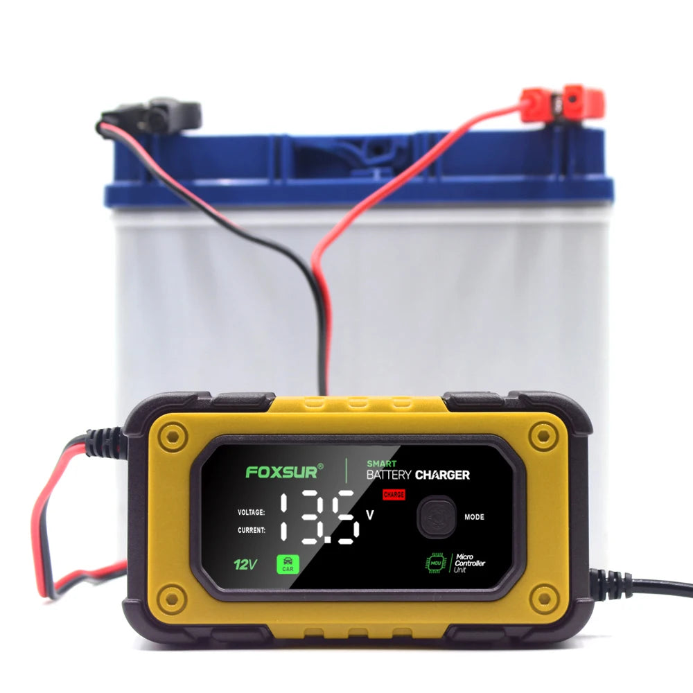 A yellow digital battery charger device is shown next to a blue storage container.