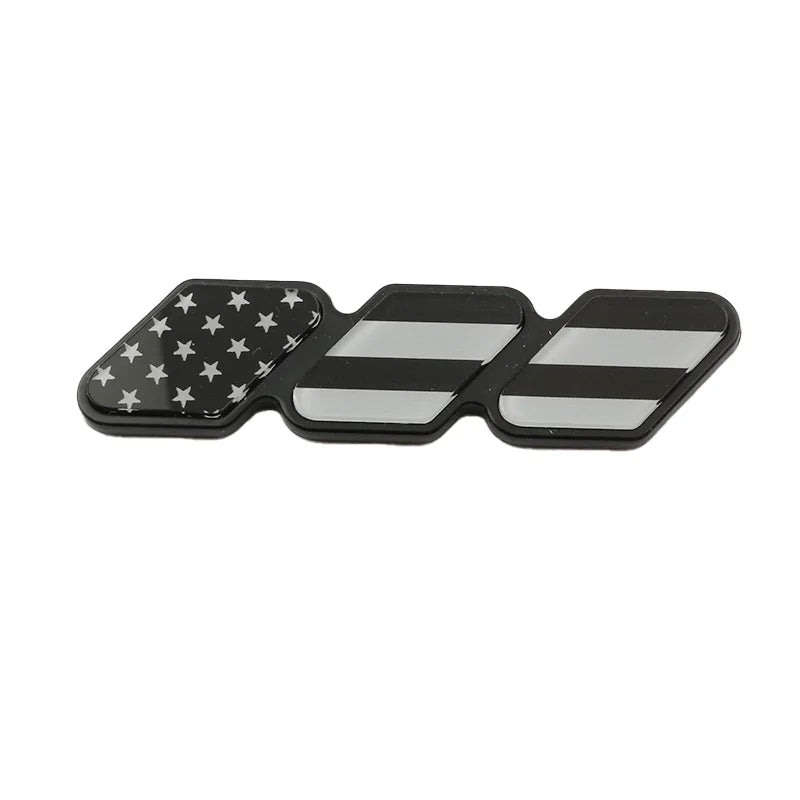 A set of three 3D car grill decals featuring American flag and black and white stripes.